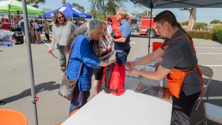 Home Depot staffers revewing emergency kit with attendee